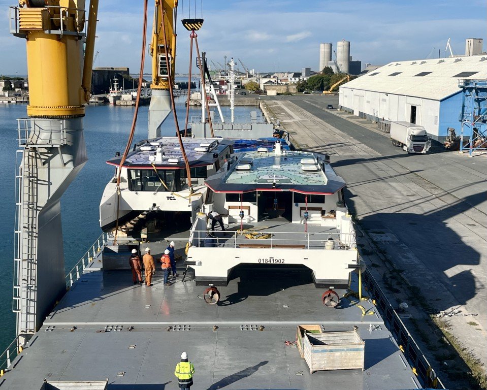 Chargement des deux bateaux à bord d'un cargo, dans le port de La Rochelle