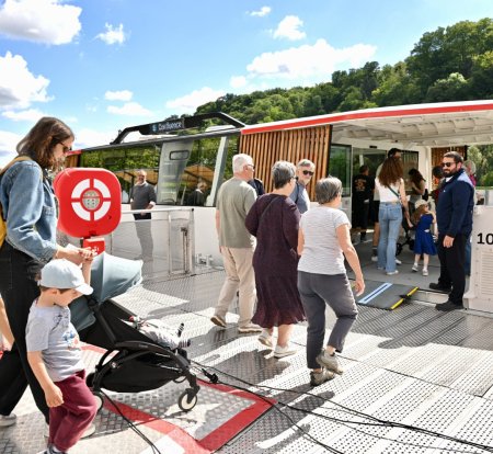 Des passagers montent à bord de la navette fluviale (crédit : Éric Soudan - Alpaca Productions)